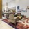 a living room with a rug and art on the wall