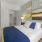a bedroom with a bed and lamps