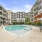 a swimming pool in a courtyard between buildings