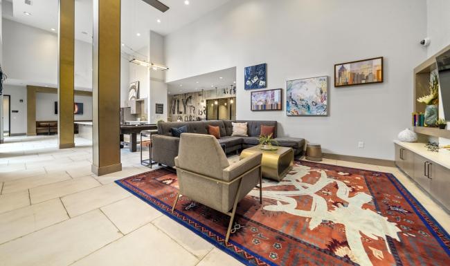 Settle into comfort at Platform at Grant Park a living room with a rug and art on the wall