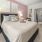 a bedroom with a bed and lamps